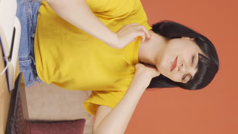 Vertical-video-of-The-young-woman-with-a-sore-neck.